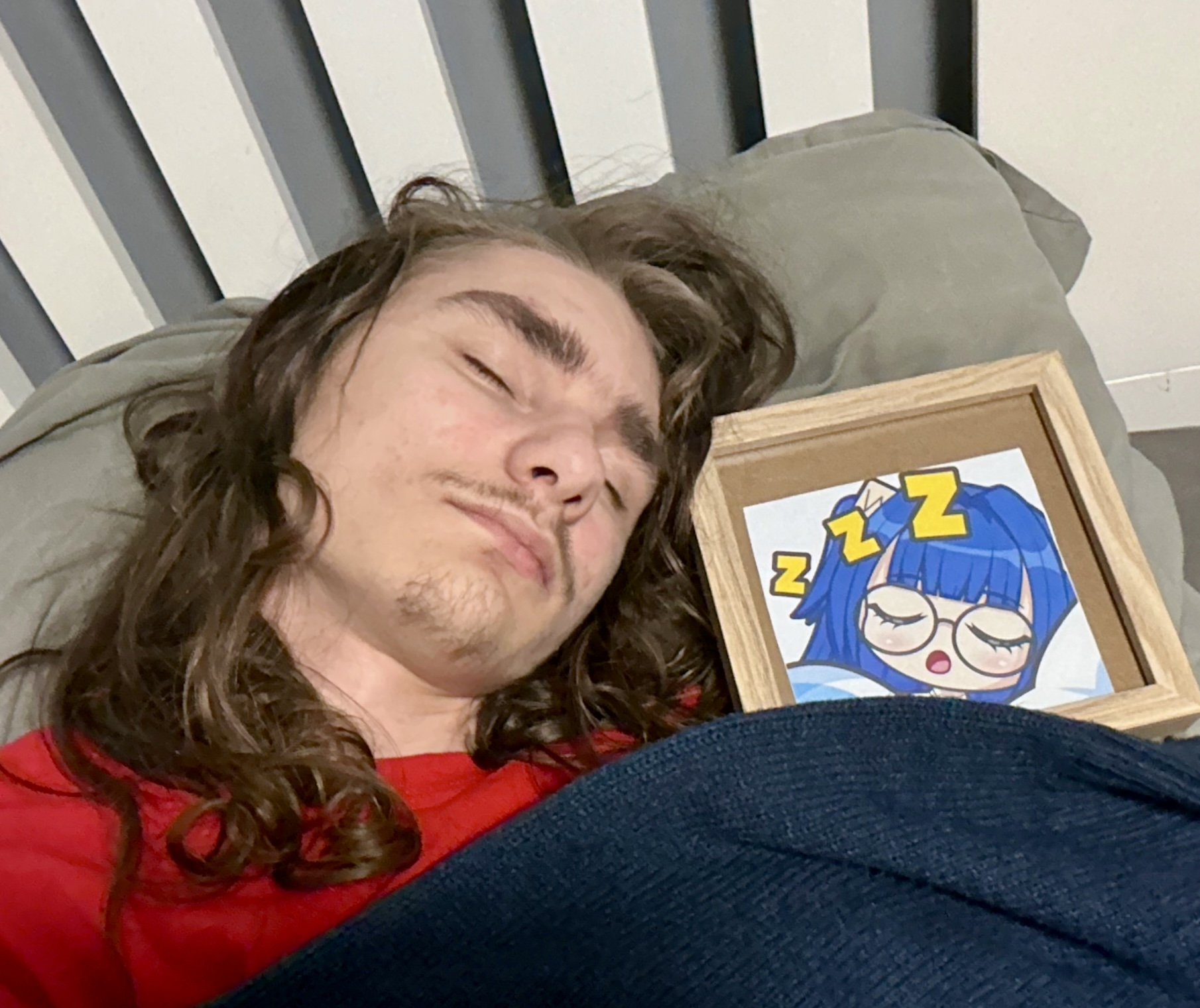 A man asleep in bed at home